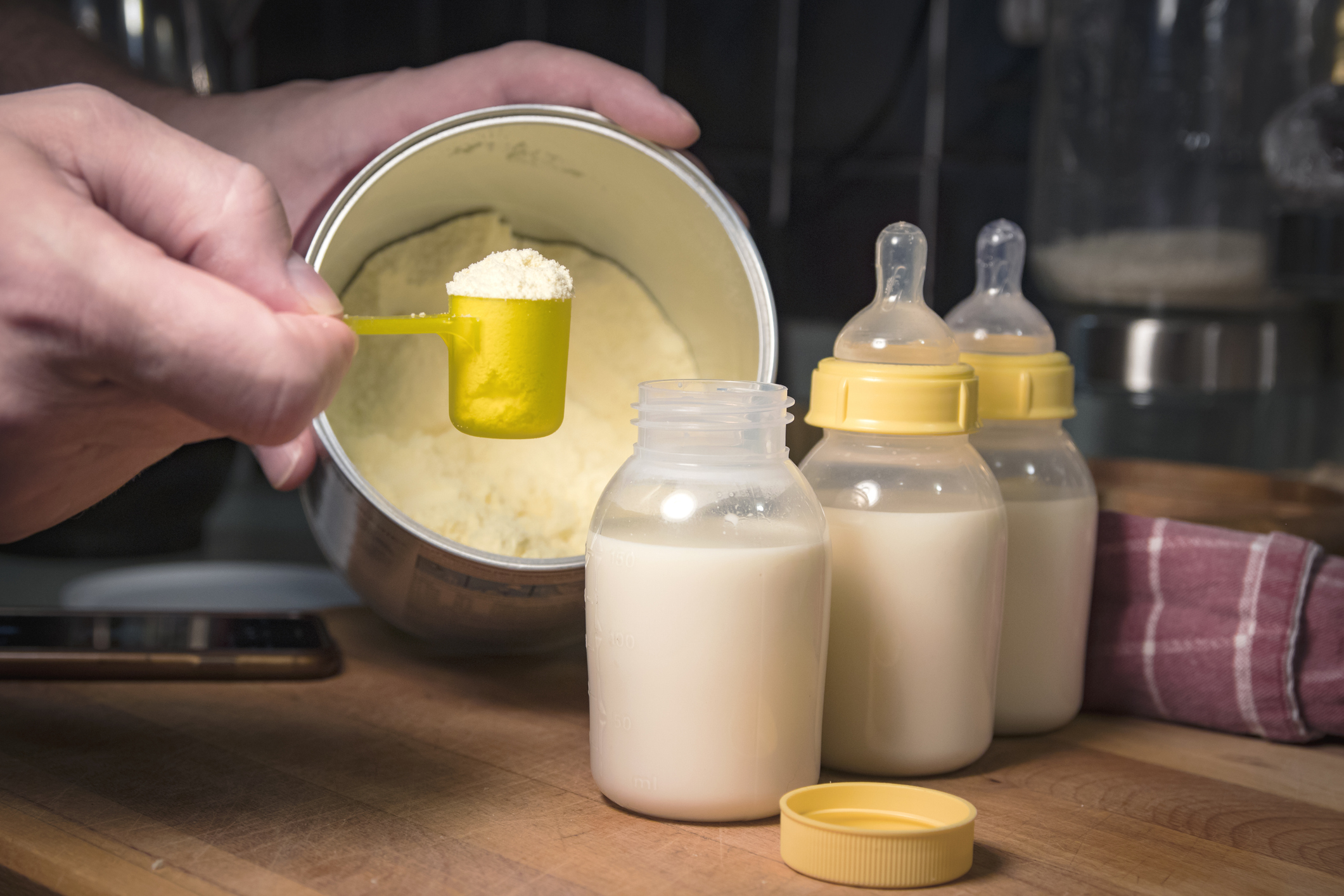 Hand mixing baby formula.