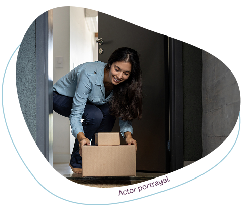 Woman retrieves care package at her front door.